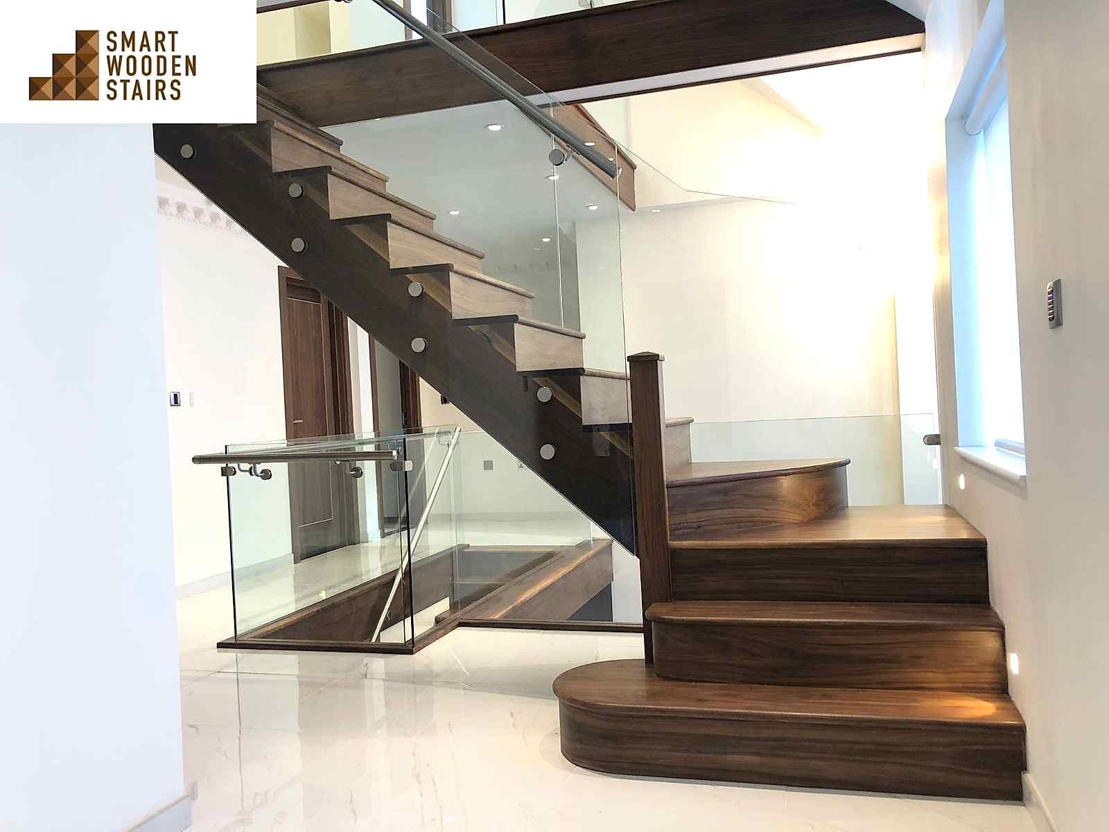 Walnut cut-string staircase with glass